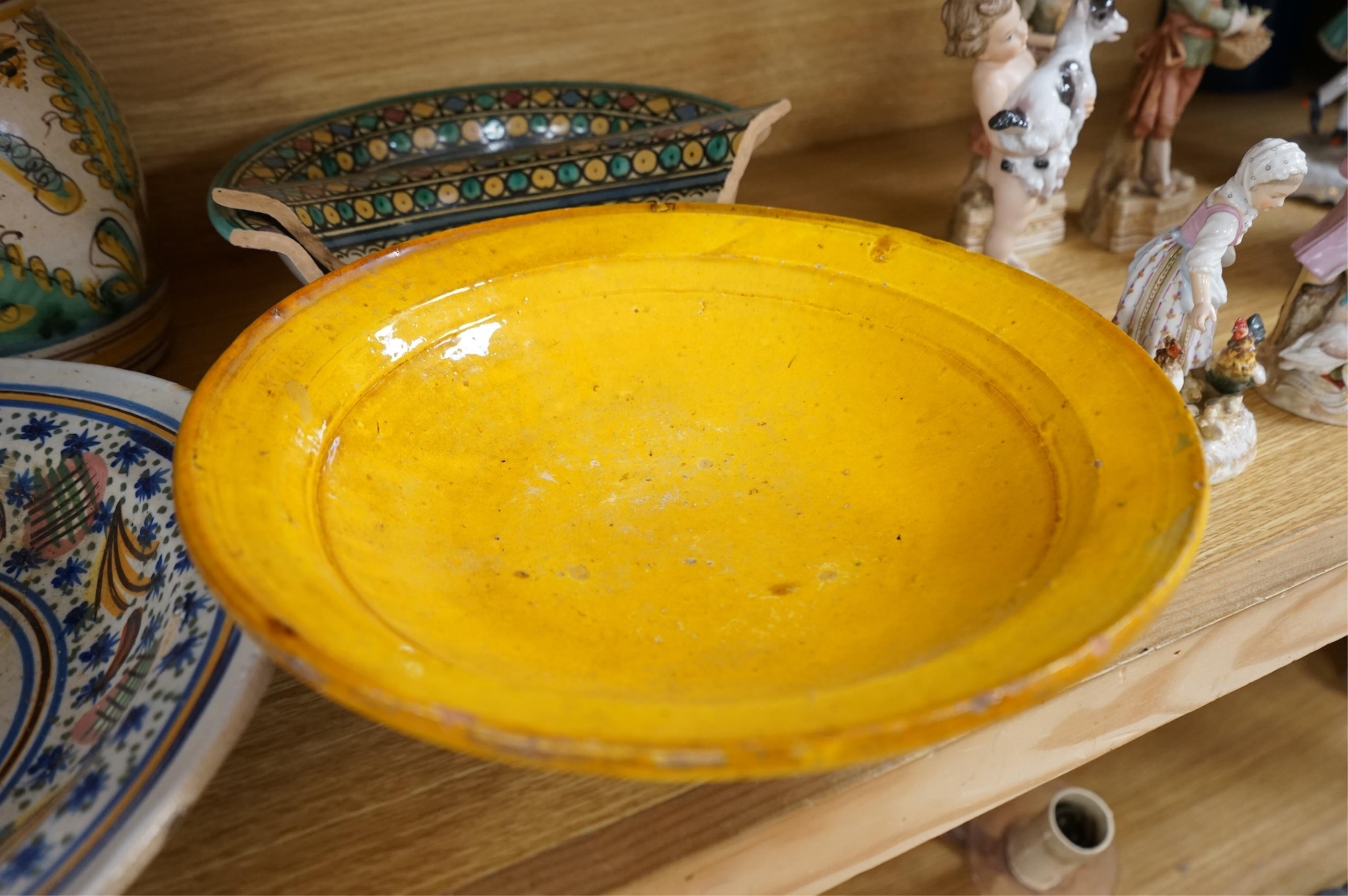 A late 17th century Spanish tin glazed jug together with Moroccan and pottery bowls and dishes (5). Jug 26cm high.